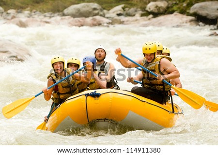 A group of adrenaline junkies conquering the wild river rapids, united as a team, in an extreme white-water rafting adventure challenge.