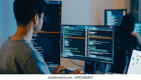 Group Adult Asia male, female freelance typing write prompt AI bot IT app smart program nomad, video game, terminal with coding language, designer, big data center on desktop computer in night office.