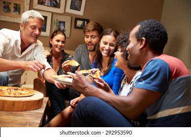 Group Of Adult Friends Eating Pizza At A House Party