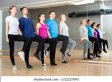 Group Of Adult People Lining Up While Fulfilling Dance Movements Of Folk Celtic Dance In Choreography Class