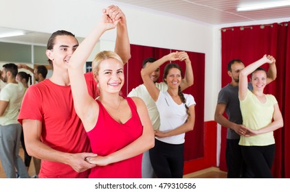 Group Of Adult Russian People Dancing Salsa In Studio