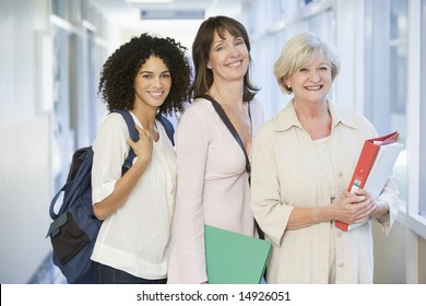 A group of adult students with backpacks standing in a campus corridor - Powered by Shutterstock