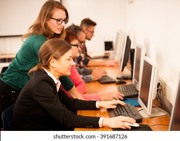 Group Of Adults Learning Computer Skills. Inter Generational Transfer Of Knowledge.