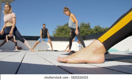 Group Of Adults Peoples Doing Yoga Outdoors On The Roof Of The House. Outdoor Group Yoga Classes Back View. Many People Do Yoga Exercises. Meditation And Wellness Lifestyle Concept