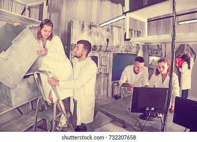 Group Of Adults In Play Trying To Get Out Of The Escape Room Stylized Under A Laboratory