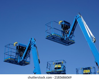 Group of aerial work platforms for construction and material handling. Close-up to the basket for moving people