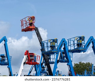Group of aerial work platforms for construction and material handling. Close-up to the basket for moving people