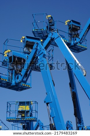 Group of aerial work platforms for construction and material handling. Close-up to the basket for moving people