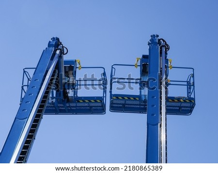 Group of aerial work platforms for construction and material handling. Close-up to the basket for moving people