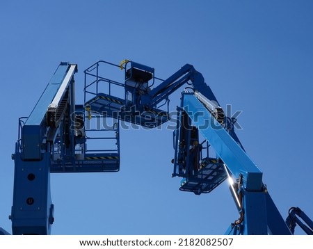 Group of aerial work platforms for construction and material handling. Close-up to the basket for moving people