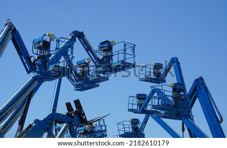 Group of aerial work platforms for construction and material handling. Close-up to the basket for moving people