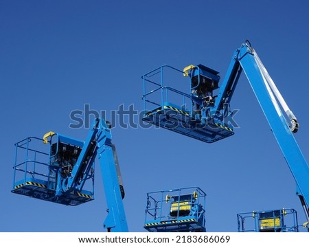 Group of aerial work platforms for construction and material handling. Close-up to the basket for moving people