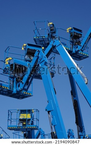 Group of aerial work platforms for construction and material handling. Close-up to the basket for moving people