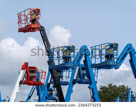 Group of aerial work platforms for construction and material handling. Close-up to the basket for moving people