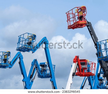 Group of aerial work platforms for construction and material handling. Close-up to the basket for moving people