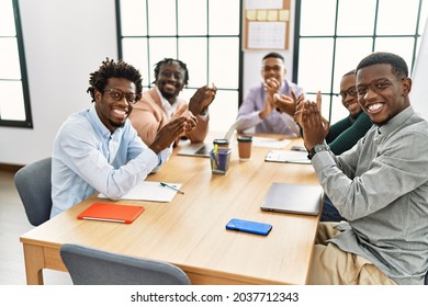 Group Of African American Business Workers Smiling And Clapping Looking To The Camera At The Office.