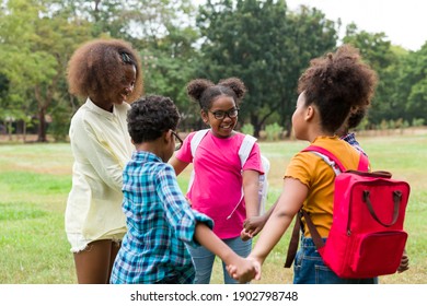 Group Of African American Children Joining Their Hands In The Park. Diverse Black Children Joining Their Hands. Successful And Teamwork Concept