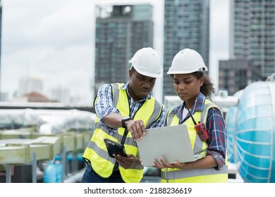 Group of African American engineer worker working in sewer pipes area at construction site. Male engineer and woman engineer work with laptop computer for maintenance sewer pipes, water tank - Powered by Shutterstock