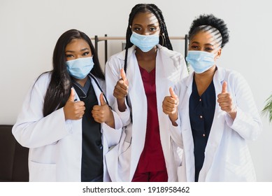 Group Of African American Female Doctors In Protective Masks On Their Faces