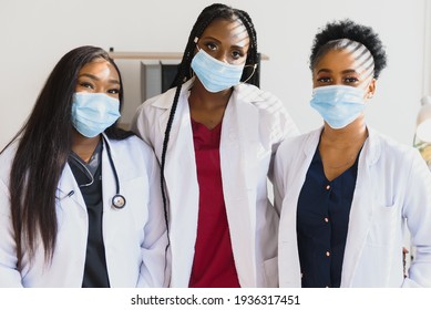 Group of African American female doctors in protective masks on their faces - Shutterstock ID 1936317451