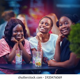 a Group of African American Friends having fun at the street restaurant, summer party