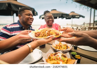 A Group Of African American Friends Shared Tacos At A Beach Restaurant. Garifuna Group From Guatemala.