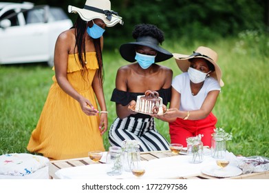 Group Of African American Girls With Facial Masks Celebrating Birthday Party Outdoor With Decor During Coronavirus Pandemia.