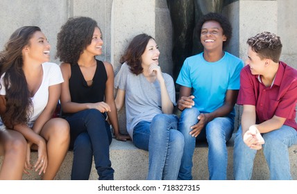 Group Of African American And Latin And Caucasian People In Discussion Outdoor In The City