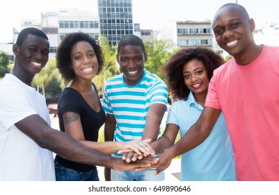 Group Of African American Men And Women Putting Hands Together