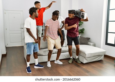 Group Of African American People Having Party Dancing At Home.