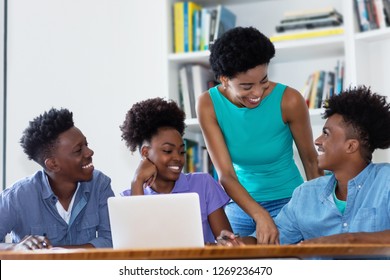 Group Of African American Students With Female Teacher At University