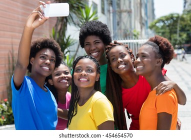 Group of african american woman taking selfie outdoor in the city in the summer