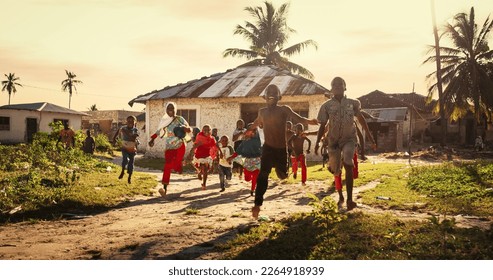 Group of African Little Children Running Towards the Camera and Laughing in Rural Village. Black Kids Full of Life and Joy Enjoying their Childhood and Playing Together. Little Faces with Big Smiles