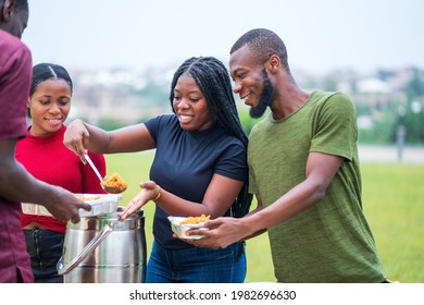 Group Of African Millennial Friends Sharing Food Outdoor On Picnic - Black People Hanging Out