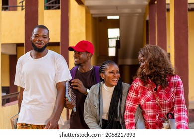 group of african students walking on campus, fun and laughter