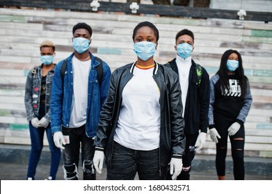 Group Of African Teenagers Friends Wearing Medical Masks Protect From Infections And Diseases Coronavirus Virus Quarantine.