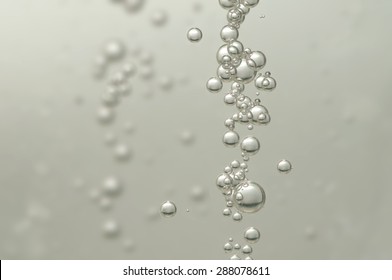 A Group Of Air Bubbles Rising In A Glass Of Wine