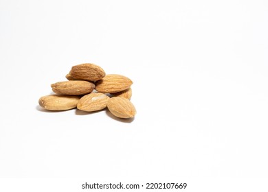 Group Almonds Isolated On White Background. Pile Of Roasted Almonds. Healthy Food Idea Concept. Copy Space, Space For Text. Empty Area. No People, Nobody.