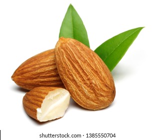 Group of almonds with leaves isolated on white background