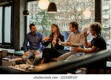 Group of amazing business people are talking and laughing together in the cafe while discussing something - Powered by Shutterstock