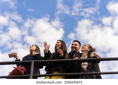 Group of amazing and young business people are laughing together while standing, low angle - Shutterstock ID 2205650671