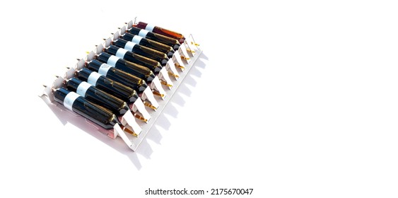 Group Of Ampoules With A Transparent Medicine In Medical Laboratory. Horizontal Perspective View Of Many Brown Ampoules Set In Pharmaceutical Packaging White Container