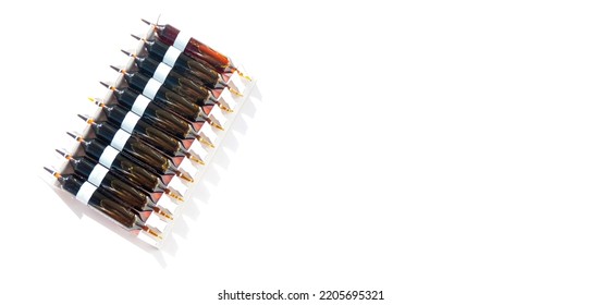  Group Of Ampoules With A Transparent Medicine In Medical Laboratory. Horizontal Perspective View Of Many Brown Ampoules Set In Pharmaceutical Packaging White Container