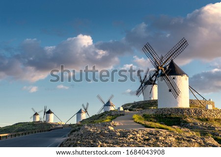 Group of ancient windmills in the town of Consuegra (Spain), on the route of the Don Quixote and Cervantes mills, at sunset.