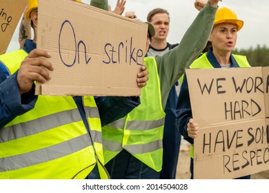 Group Of Angry Builders Or Miners With Placards Are On Strike