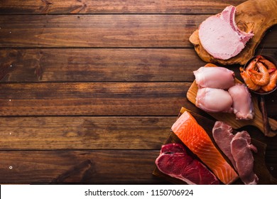 Group Of Animal Proteins, Chicken, Meat, Fish And Pork On A Wood Background