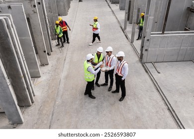 Group of Architects engineer and construction foremen review the work and talk about how the project, Prefabricated house factory construction site, Precast concrete wall panel. Aerial top view 
