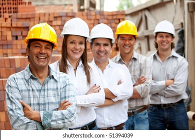 Group Of Architects And Engineers At A Construction Site Smiling