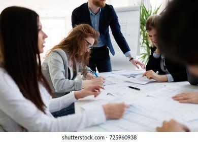 Group of architects working together on project - Shutterstock ID 725960938