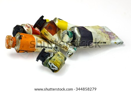 Group of artists paint tubes; used tubes of oil paints, isolated on white ground; differential focus 
